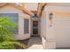 Exterior view of front door with security screen and lush landscaping at 4441 E Desert Wind Dr, Phoenix, AZ 85044