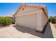 Garage door with desert landscaping and clear blue skies at 4441 E Desert Wind Dr, Phoenix, AZ 85044