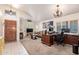 Spacious living room with plush carpeting, bright natural light, and elegant chandelier at 4441 E Desert Wind Dr, Phoenix, AZ 85044