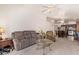 Cozy living room featuring comfortable seating, bright lighting, and seamless transition to dining area at 4441 E Desert Wind Dr, Phoenix, AZ 85044