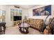 Cozy living room featuring a floral sofa and window with bright natural light at 4441 E Desert Wind Dr, Phoenix, AZ 85044