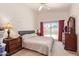 Comfortable main bedroom with backyard access and views of the pool at 4441 E Desert Wind Dr, Phoenix, AZ 85044