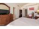 Bedroom featuring neutral tones, wooden dresser, and TV at 4441 E Desert Wind Dr, Phoenix, AZ 85044