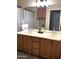 Well-lit bathroom offers double sinks and a large mirror at 4628 W Whispering Wind Dr, Glendale, AZ 85310