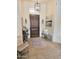 Inviting entryway featuring a decorative rug, bench, and stylish light fixtures at 4628 W Whispering Wind Dr, Glendale, AZ 85310