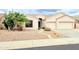 Charming single-story home with a well-manicured desert landscape and a two-car garage at 4628 W Whispering Wind Dr, Glendale, AZ 85310