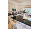Kitchen island featuring sleek countertops, modern appliances, and white cabinetry at 4628 W Whispering Wind Dr, Glendale, AZ 85310