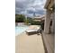 Comfortable poolside lounge area with a stylish chaise and well-maintained patio at 4628 W Whispering Wind Dr, Glendale, AZ 85310