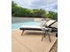 Close-up of the swimming pool, chaise lounge, and manicured surrounding landscape at 4628 W Whispering Wind Dr, Glendale, AZ 85310