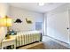 Cozy bedroom with dinosaur-themed decor, a comfortable bed, and natural light from the window at 4712 E Lone Cactus Dr, Phoenix, AZ 85050