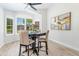 Bright dining area features a modern light fixture and a table with seating for four, complemented by a large window at 4712 E Lone Cactus Dr, Phoenix, AZ 85050