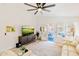 Bright living room with a modern ceiling fan, wood floors, and sliding door access to the pool area at 4712 E Lone Cactus Dr, Phoenix, AZ 85050