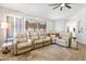 Comfortable living room featuring a large sectional sofa, decorative rug, and neutral tones throughout at 4712 E Lone Cactus Dr, Phoenix, AZ 85050