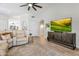 Spacious living room with vaulted ceiling, plush seating and large TV at 4712 E Lone Cactus Dr, Phoenix, AZ 85050