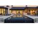 Tranquil backyard at dusk with a swimming pool reflecting the home's lights and architecture at 4864 E Lafayette Blvd, Phoenix, AZ 85018