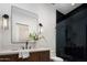 Elegant bathroom with dark wood cabinets, black shower tiles, sleek fixtures, and decor at 4864 E Lafayette Blvd, Phoenix, AZ 85018