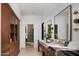 Bathroom with double sinks, stone countertop, and natural wood cabinets at 4864 E Lafayette Blvd, Phoenix, AZ 85018