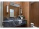 Modern powder room with marble countertop and wood paneled walls at 4864 E Lafayette Blvd, Phoenix, AZ 85018