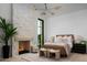 Bright bedroom with a stone fireplace, large windows, and hardwood floors at 4864 E Lafayette Blvd, Phoenix, AZ 85018
