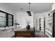 Bright kitchen with a wooden island, custom lighting fixtures, and white cabinets at 4864 E Lafayette Blvd, Phoenix, AZ 85018