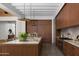 Well-lit kitchen features an island with marble countertop, wood cabinets, and high-end appliances at 4864 E Lafayette Blvd, Phoenix, AZ 85018