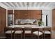 The kitchen island offers barstool seating, stylish pendant lighting, and beautiful views of the backyard at 4864 E Lafayette Blvd, Phoenix, AZ 85018