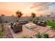 Relaxing backyard features a fire pit with ample seating, artificial grass, and desert landscaping at 4920 W Walatowa St, Laveen, AZ 85339