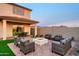Inviting backyard features a well-kept lawn, covered patio, and an outdoor seating area perfect for relaxing at 4920 W Walatowa St, Laveen, AZ 85339