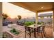 Enjoy the cozy fire pit, spacious seating, and desert landscaping viewed from the covered patio in this backyard oasis at 4920 W Walatowa St, Laveen, AZ 85339
