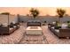 Relaxing backyard features a cozy fire pit with plenty of seating, a manicured lawn, and desert landscaping at 4920 W Walatowa St, Laveen, AZ 85339