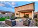 Large backyard with manicured lawn, covered patio, and an inviting outdoor seating area perfect for gatherings at 4920 W Walatowa St, Laveen, AZ 85339