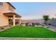 Backyard with green turf, pavers, and comfortable seating around a modern fire pit to enjoy outdoor relaxation at 4920 W Walatowa St, Laveen, AZ 85339