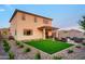 Spacious backyard with manicured lawn, covered patio, and an outdoor seating area perfect for entertaining at 4920 W Walatowa St, Laveen, AZ 85339