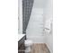 This bathroom features a tub shower, neutral color palette, and hard surface flooring at 4920 W Walatowa St, Laveen, AZ 85339