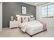 This bedroom features a large window, grey color palette, and modern décor at 4920 W Walatowa St, Laveen, AZ 85339
