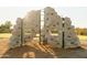 Outdoor climbing wall with ladder and varied grips, set on wood-chip ground covering at 4920 W Walatowa St, Laveen, AZ 85339