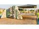 Playground climbing wall next to a shaded picnic area, promoting fun and community at 4920 W Walatowa St, Laveen, AZ 85339