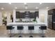 Modern kitchen with a large island, barstool seating, and stainless steel appliances at 4920 W Walatowa St, Laveen, AZ 85339