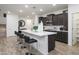 Bright kitchen boasts a spacious island with seating, modern appliances, and stylish dark wood cabinetry at 4920 W Walatowa St, Laveen, AZ 85339