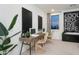 Bright living room features a modern desks, stylish furniture and decor, and large windows at 4920 W Walatowa St, Laveen, AZ 85339