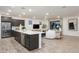 Open-concept living room and kitchen area with sleek appliances and stylish design at 4920 W Walatowa St, Laveen, AZ 85339