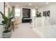 Bright living room features a modern desk, stylish furniture and decor, and large windows at 4920 W Walatowa St, Laveen, AZ 85339