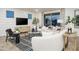 Bright living room features a modern design, stylish furniture and decor, and sliding glass doors at 4920 W Walatowa St, Laveen, AZ 85339