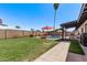 Large grassy backyard showcasing a pool, patio, and block fence that offers privacy at 5226 W Redfield Rd, Glendale, AZ 85306