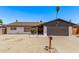 Charming single-story home features low maintenance landscaping, painted brick, and a two-car garage at 5226 W Redfield Rd, Glendale, AZ 85306