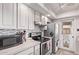 Updated kitchen boasts modern backsplash, stainless steel appliances, and plenty of cabinet storage at 5226 W Redfield Rd, Glendale, AZ 85306