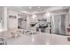 Well-lit kitchen featuring modern appliances, white cabinets, ample counter space, and seamless connection to dining at 5226 W Redfield Rd, Glendale, AZ 85306