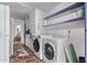 Convenient laundry room with modern washer and dryer, shelving, and storage space at 5226 W Redfield Rd, Glendale, AZ 85306