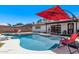 Sparkling blue pool featuring an umbrella and patio area, ideal for summer relaxation at 5226 W Redfield Rd, Glendale, AZ 85306