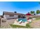 Backyard pool featuring a diving board, red patio furniture, and view of the home's exterior at 5226 W Redfield Rd, Glendale, AZ 85306